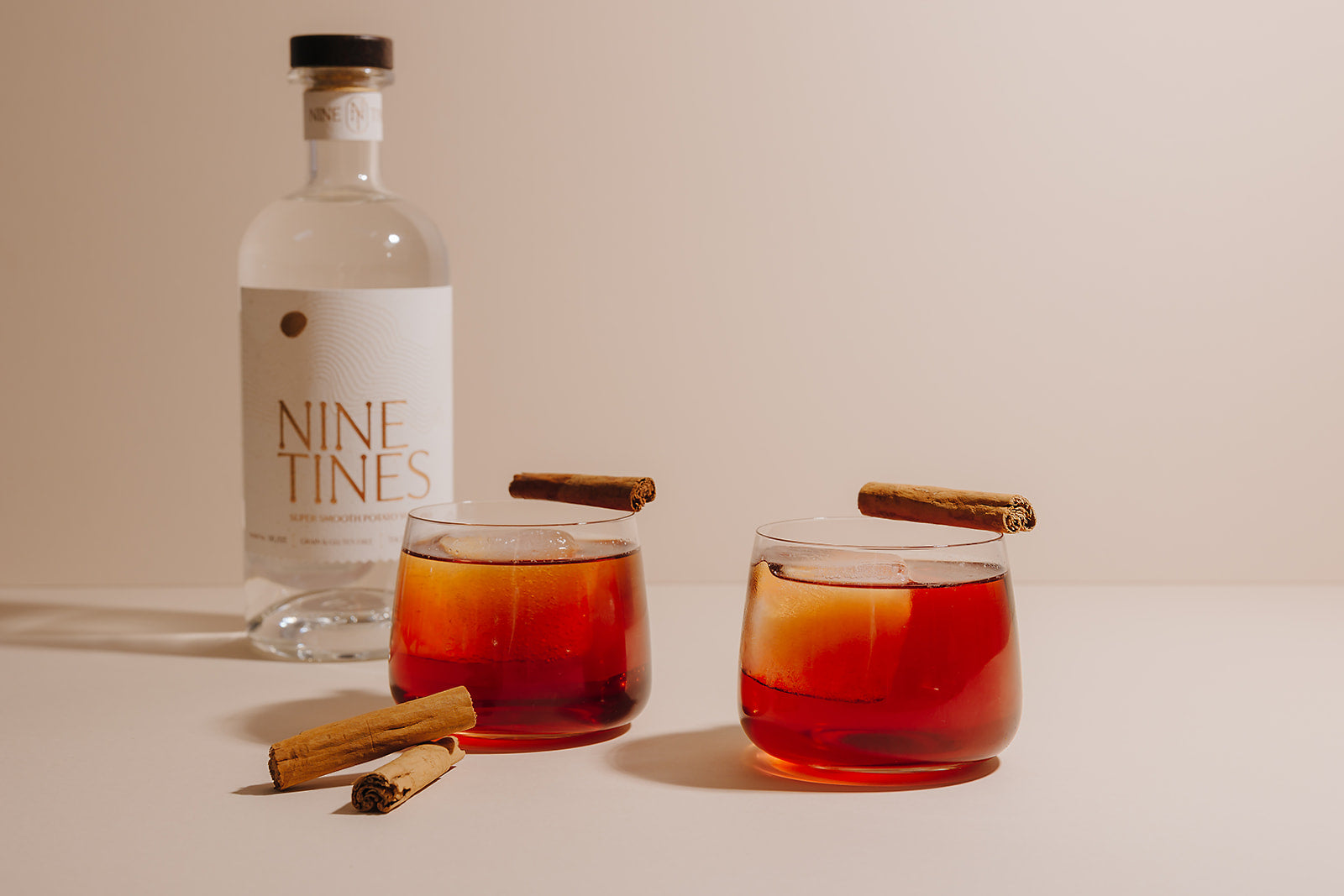 Nine Tines Autumn Negroni cocktail served in rocks glass with cinnamon stick garnish