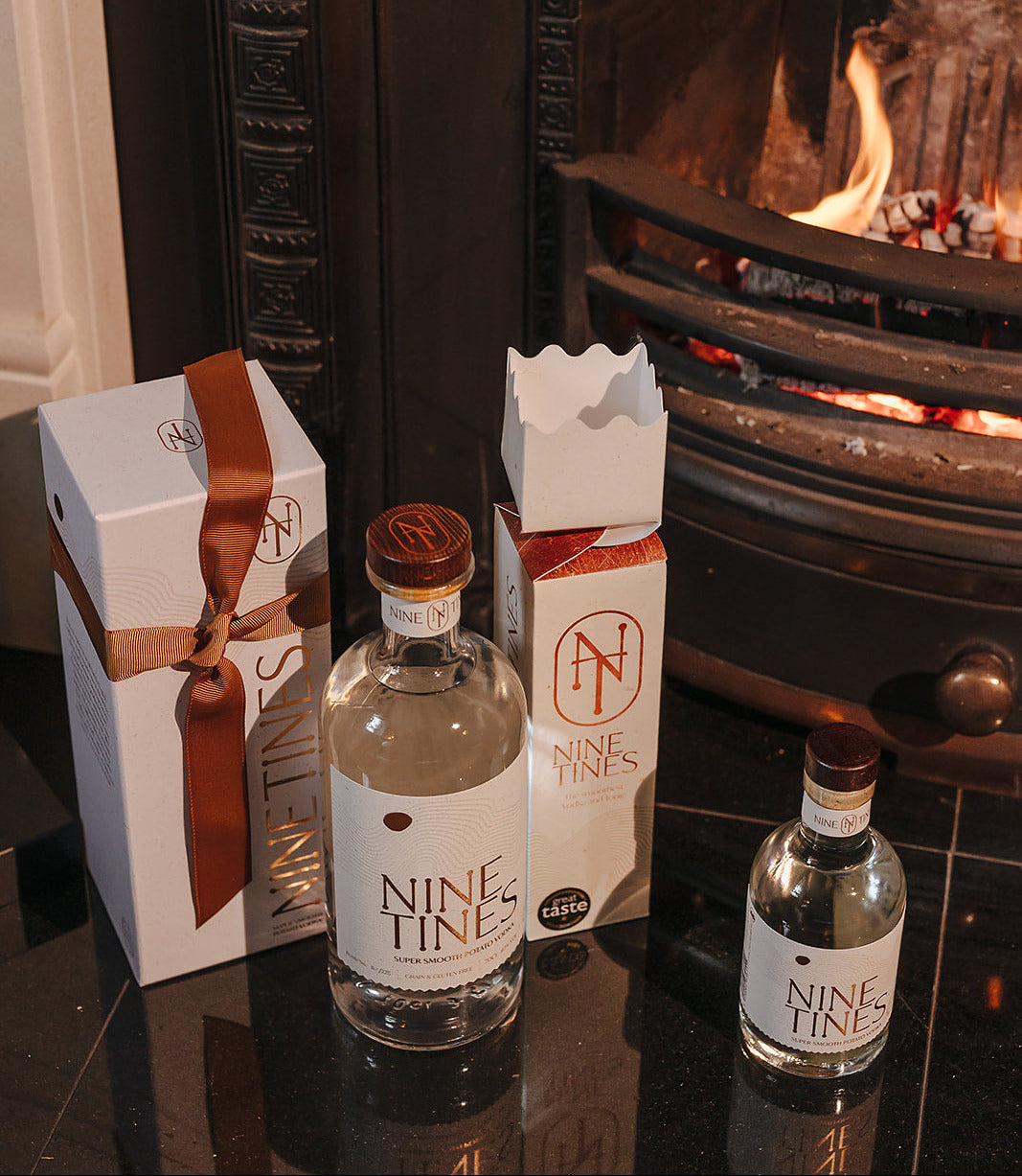 Nine Tines Vodka range in front of roaring fire