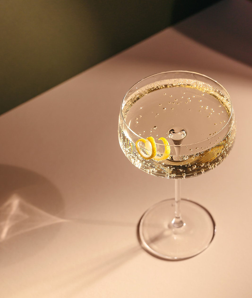 Nine Tines Champagne Martini served in coupe glass with lemon twist garnish