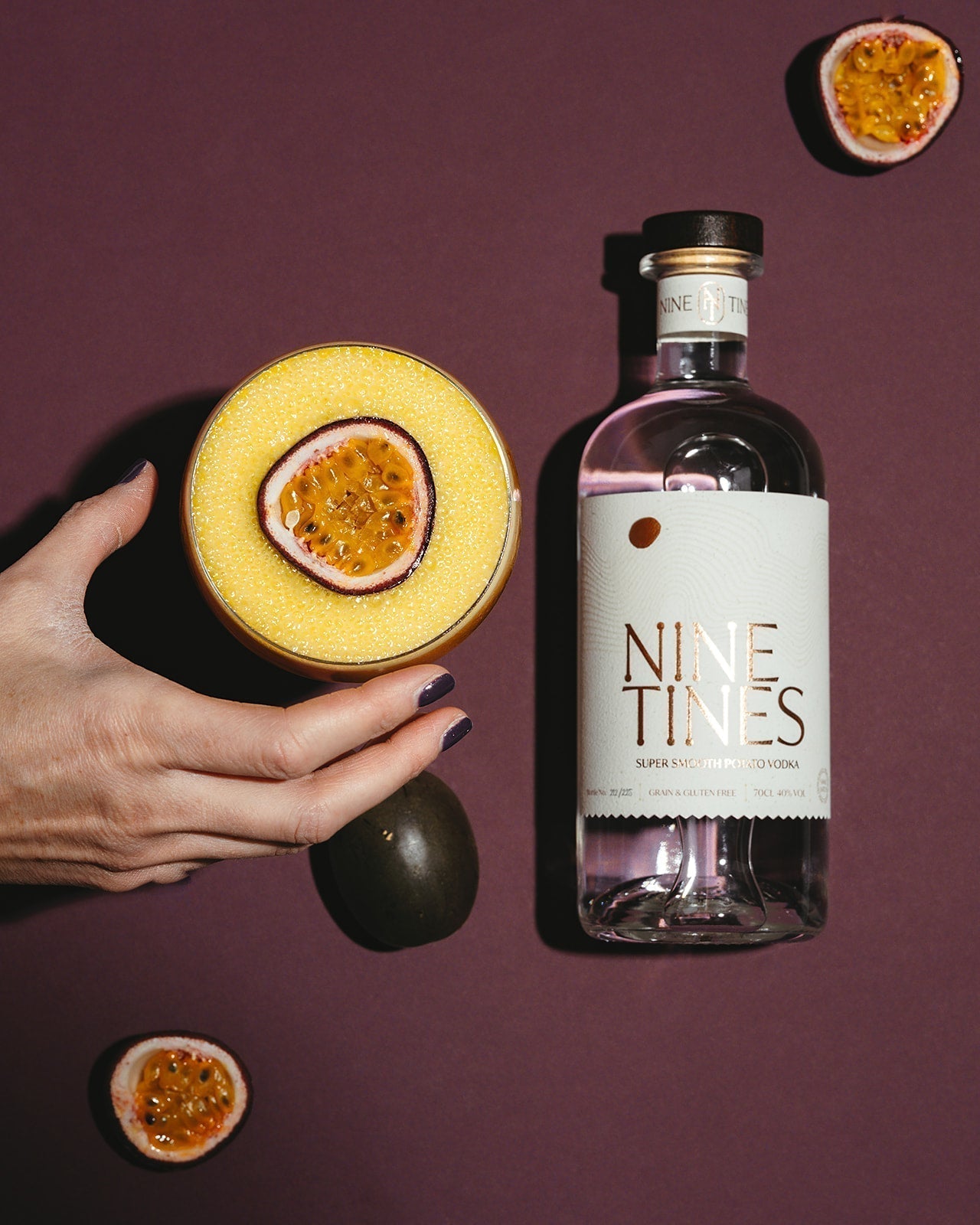 Nine Tines Passion Fruit Martini garnished with half a passion fruit