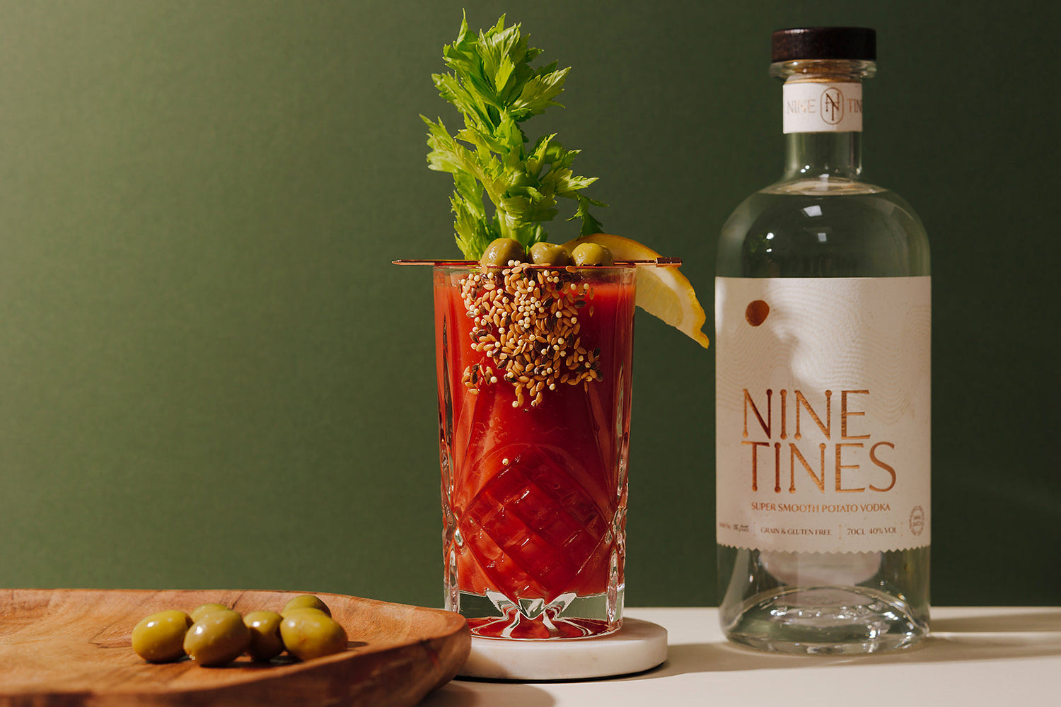 Nine Tines Bloody Mary served with celery stick and black pepper garnish in tall glass