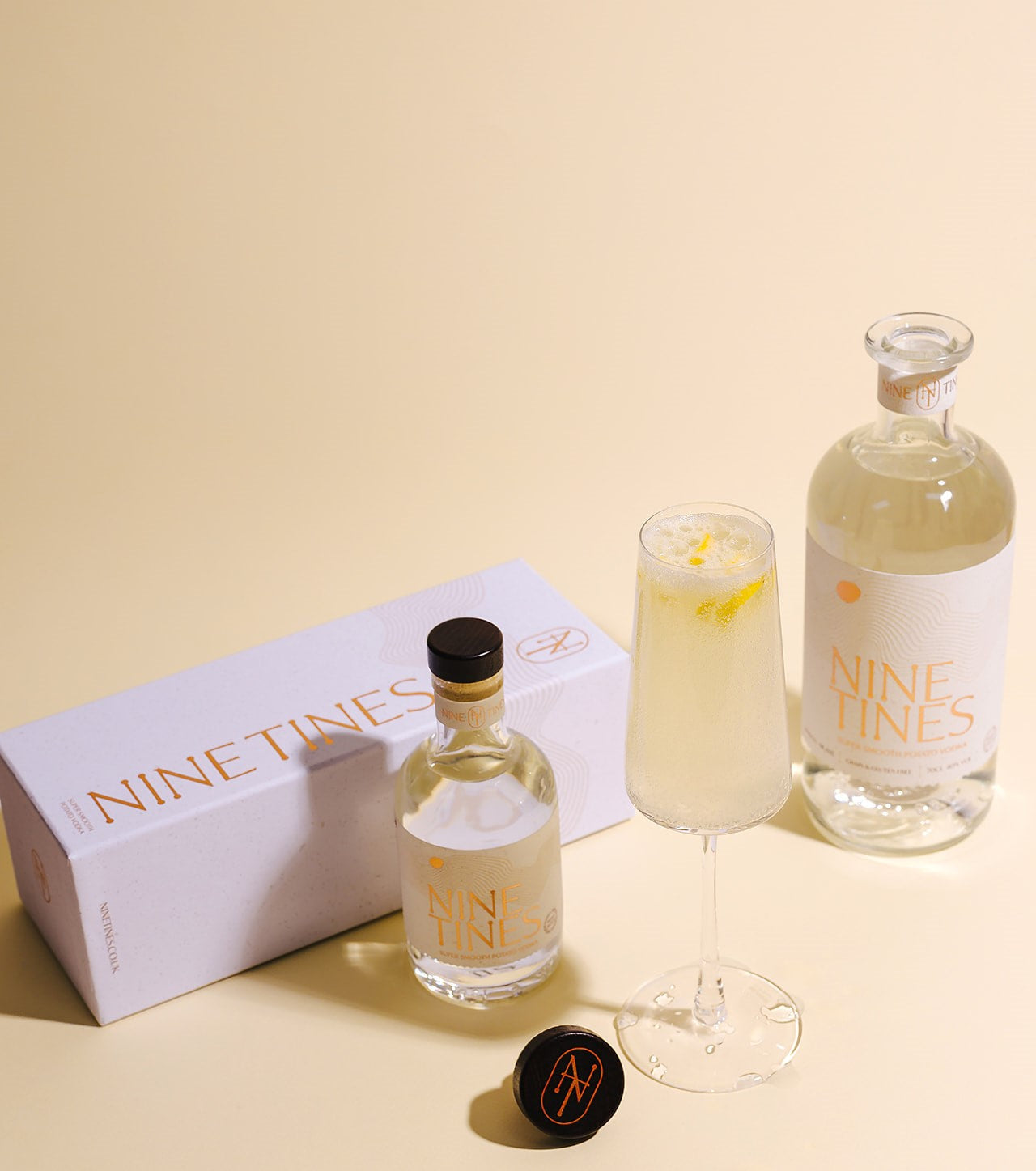 Nine Tines 75 cocktail served in champagne flute with lemon twist and English sparkling wine